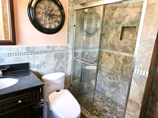 a bathroom with a toilet a sink and a mirror