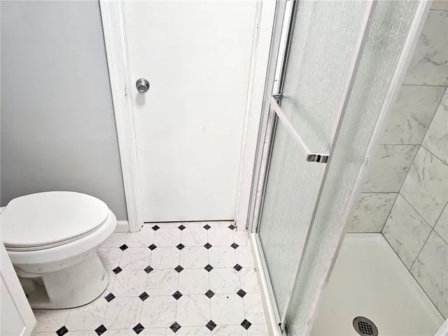 a bathroom with a glass shower door