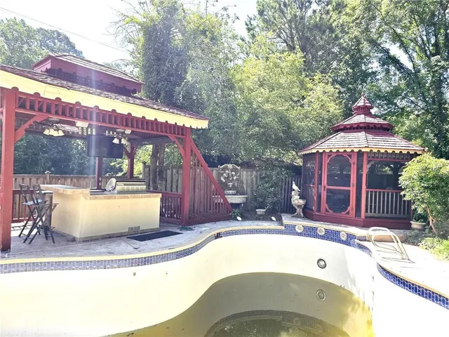 a view of swimming pool with a patio and a yard