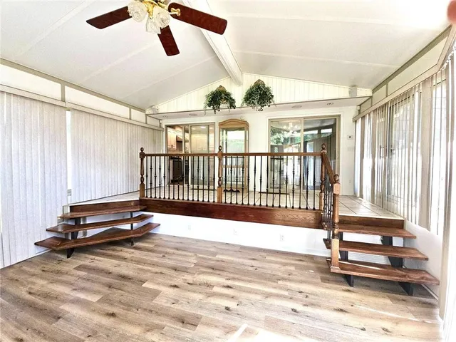a view of an empty room and wooden floor