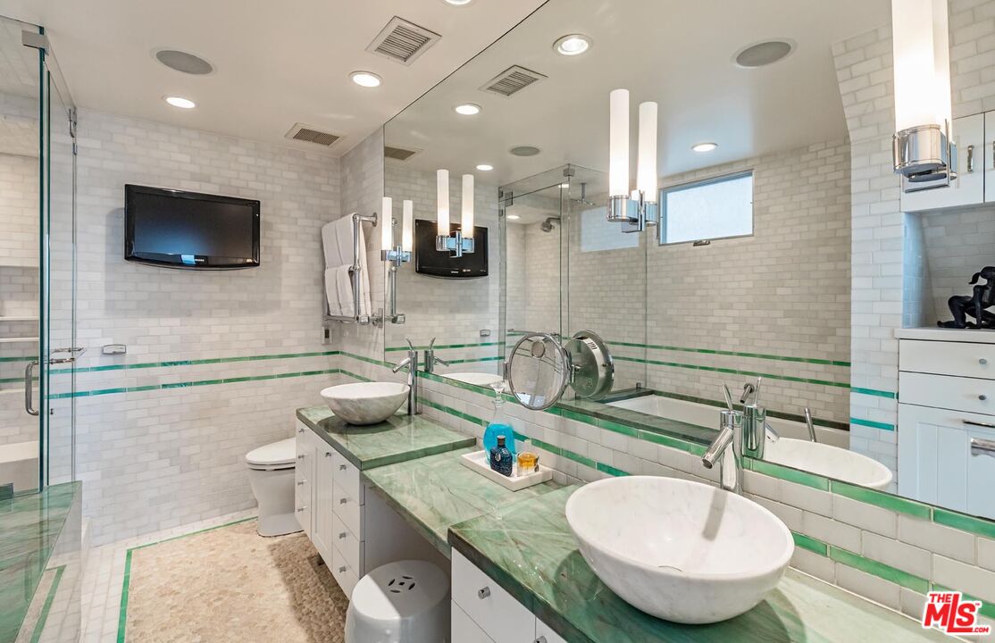 23416 Malibu Colony Road Malibu, CA 90265 - Photo 17 of 26 a kitchen with stainless steel appliances a sink and microwave