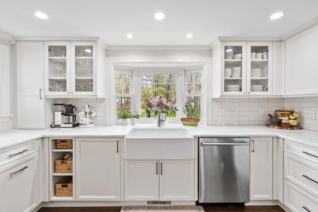 244 Powder Mill Road Concord, MA 01742 - Photo 10 of 34 a kitchen with a sink cabinets and window