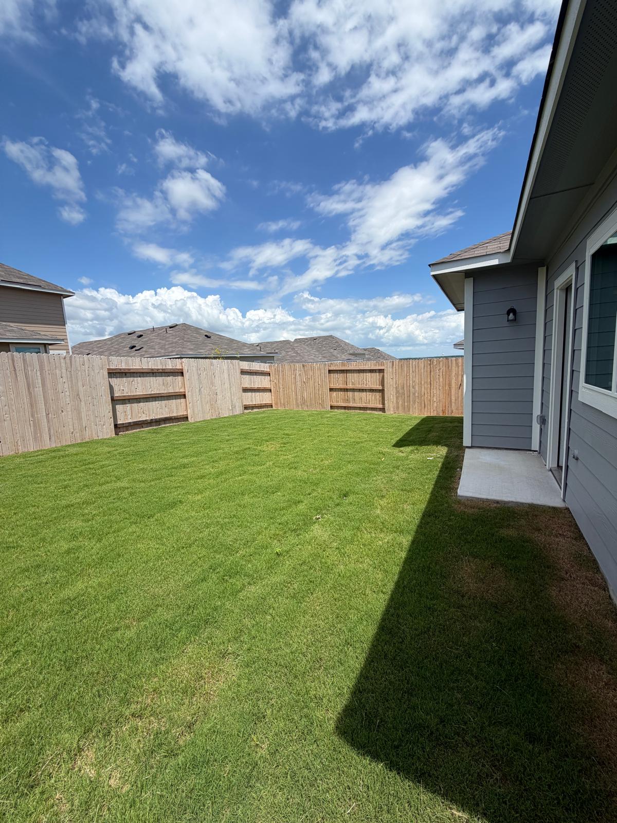 2612 Towy Road Manor, TX 78653 - Photo 32 of 35 A well-maintained lawn awaits outdoor leisure within a private fenced yard.