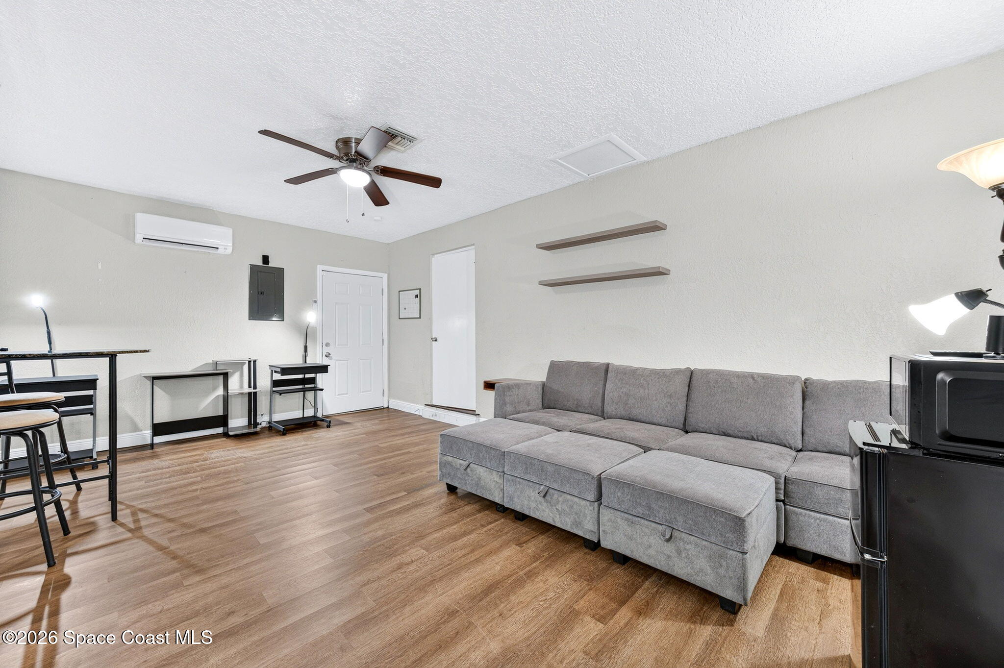 996 Botany Lane Rockledge, FL 32955 - Photo 18 of 35 a living room with furniture and a wooden floor