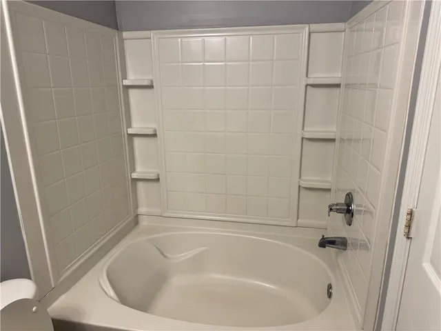 a white bath tub sitting in a bathroom