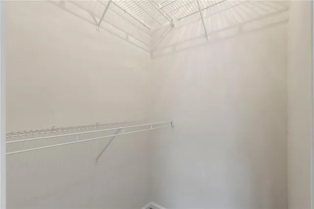 a bathroom with a granite countertop sink a bathtub and next to a window