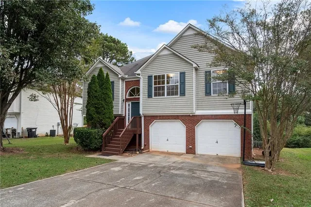 a front view of a house with a yard and garage