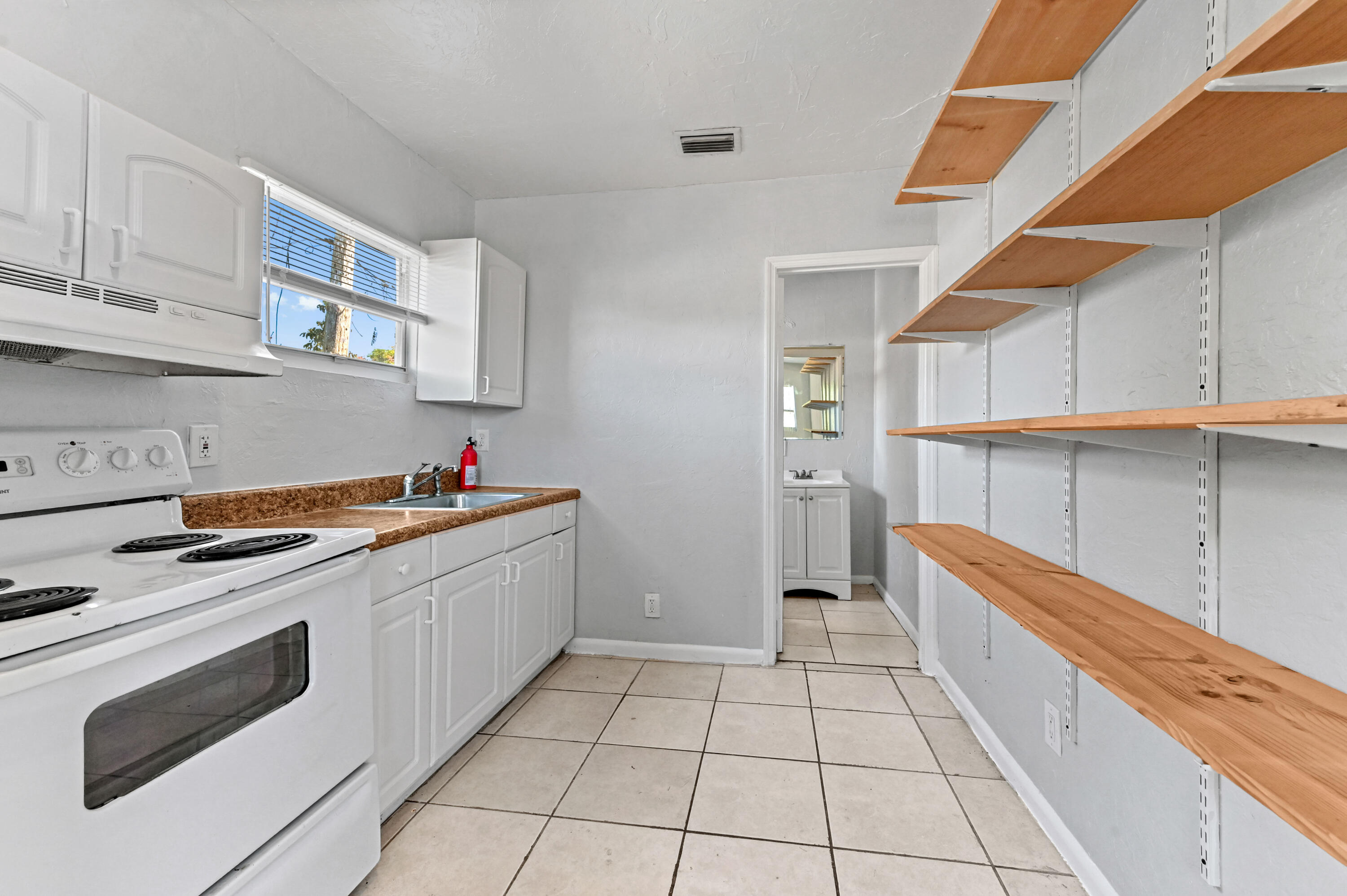 515 Putnam Road West Palm Beach, FL 33405 - Photo 14 of 23 a kitchen with a sink and cabinets