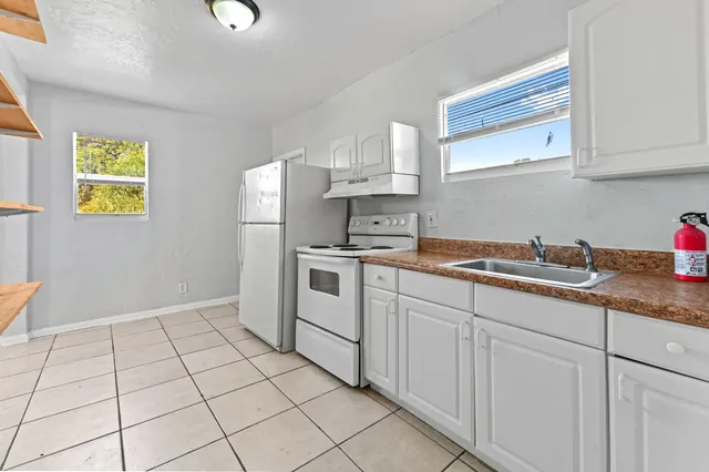 a kitchen with a sink and cabinets