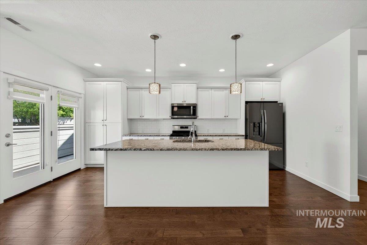 4204 East Silverking Lane Meridian, ID 83642 - Photo 12 of 40 Kitchen with a central island featuring a stone countertop