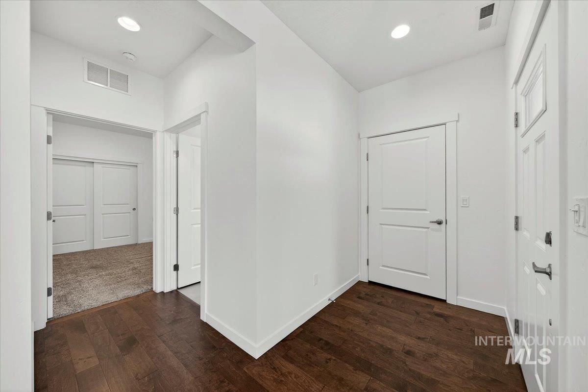 4204 East Silverking Lane Meridian, ID 83642 - Photo 18 of 40 Hallway featuring rich wood-finish flooring, white walls, and recessed lighting