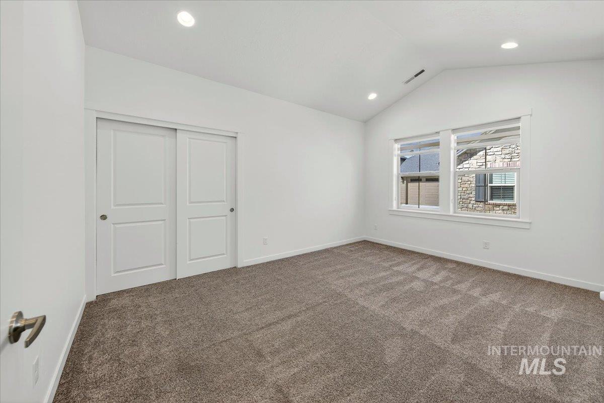 4204 East Silverking Lane Meridian, ID 83642 - Photo 20 of 40 Room featuring vaulted ceilings with recessed lighting, neutral carpet flooring, and white trim