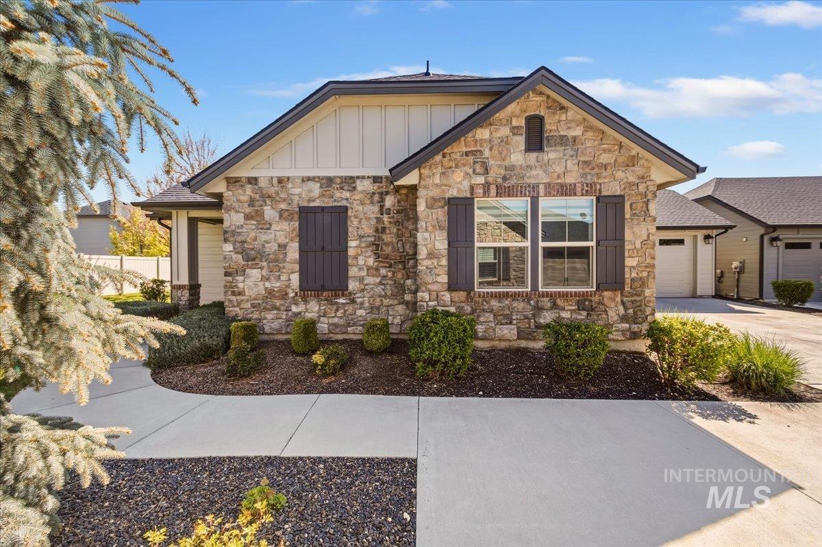 4204 East Silverking Lane Meridian, ID 83642 - Photo 2 of 40 Stone and siding exterior with dark shutters