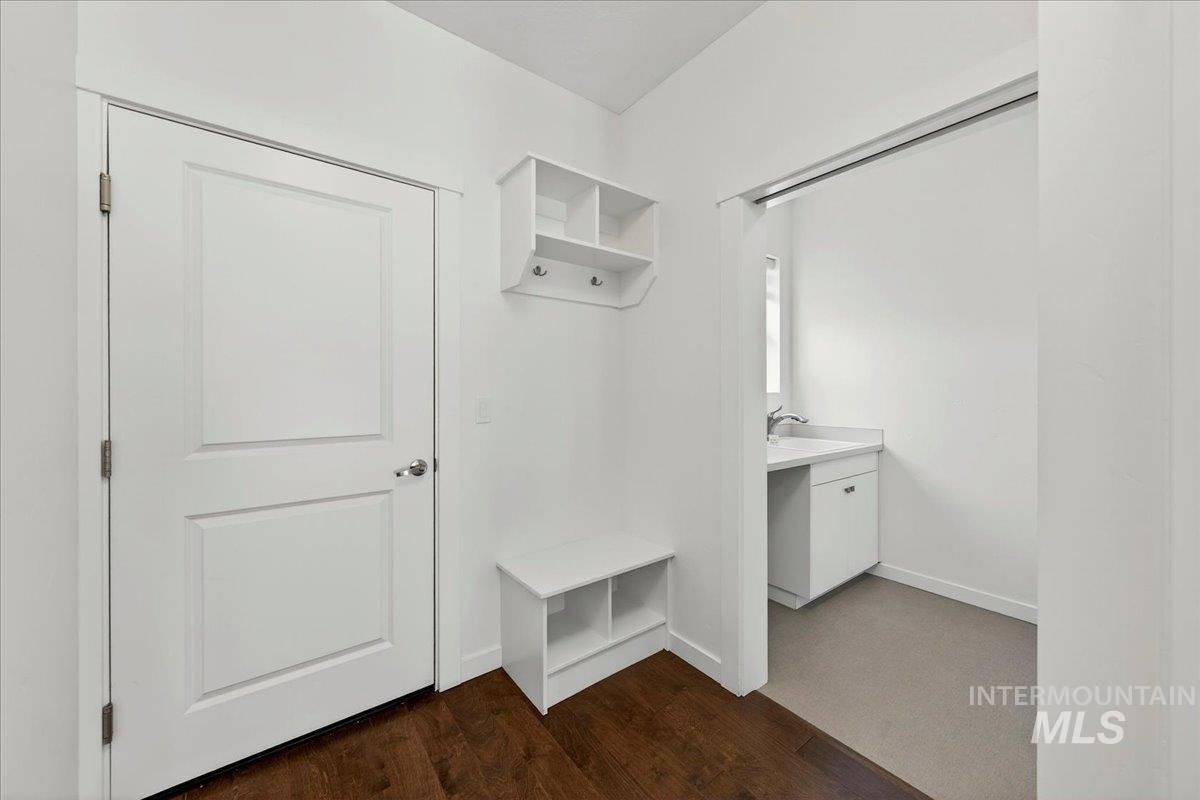 4204 East Silverking Lane Meridian, ID 83642 - Photo 21 of 40 Entry area with dark wood-finish flooring, white walls, and a white paneled door