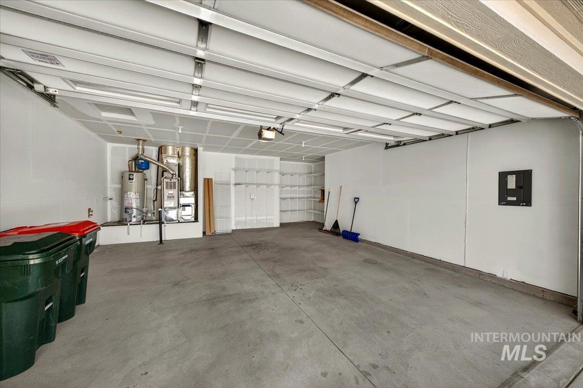 4204 East Silverking Lane Meridian, ID 83642 - Photo 30 of 40 Spacious garage featuring a concrete floor, painted drywall, and exposed ceiling joists