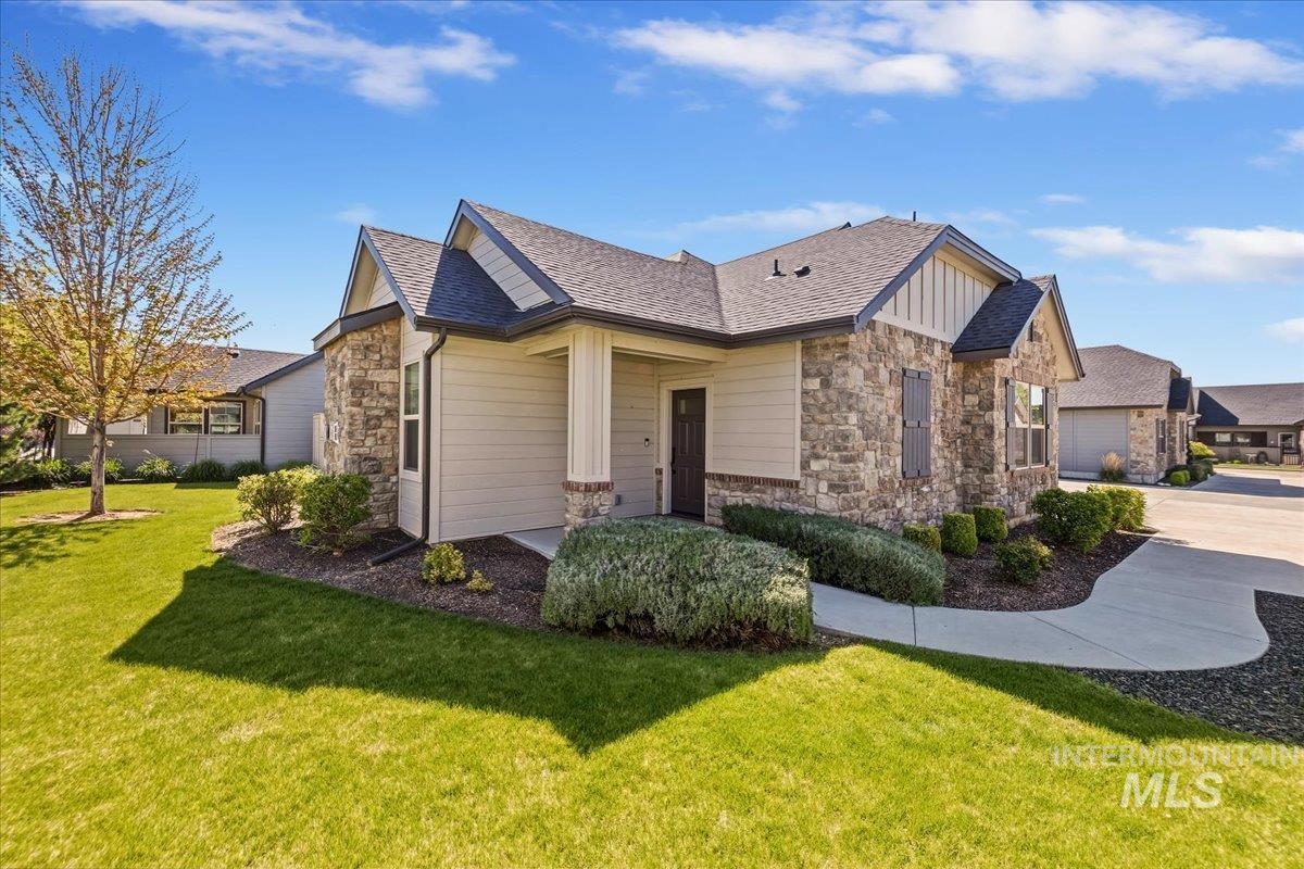 4204 East Silverking Lane Meridian, ID 83642 - Photo 3 of 40 Exterior featuring stone and siding finishes, a covered entry, gabled rooflines, and a concrete walkway