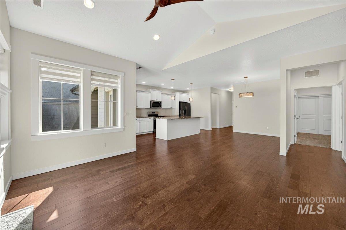4204 East Silverking Lane Meridian, ID 83642 - Photo 8 of 40 Open-concept living area featuring wood-finish flooring, vaulted ceilings, and recessed lighting