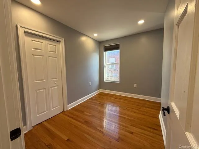 an empty room with closet and a window