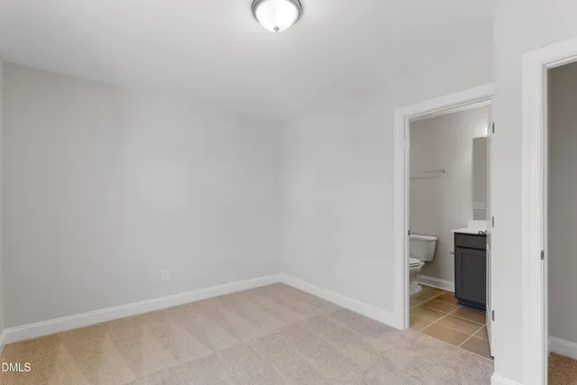 a view of an empty room and closet area