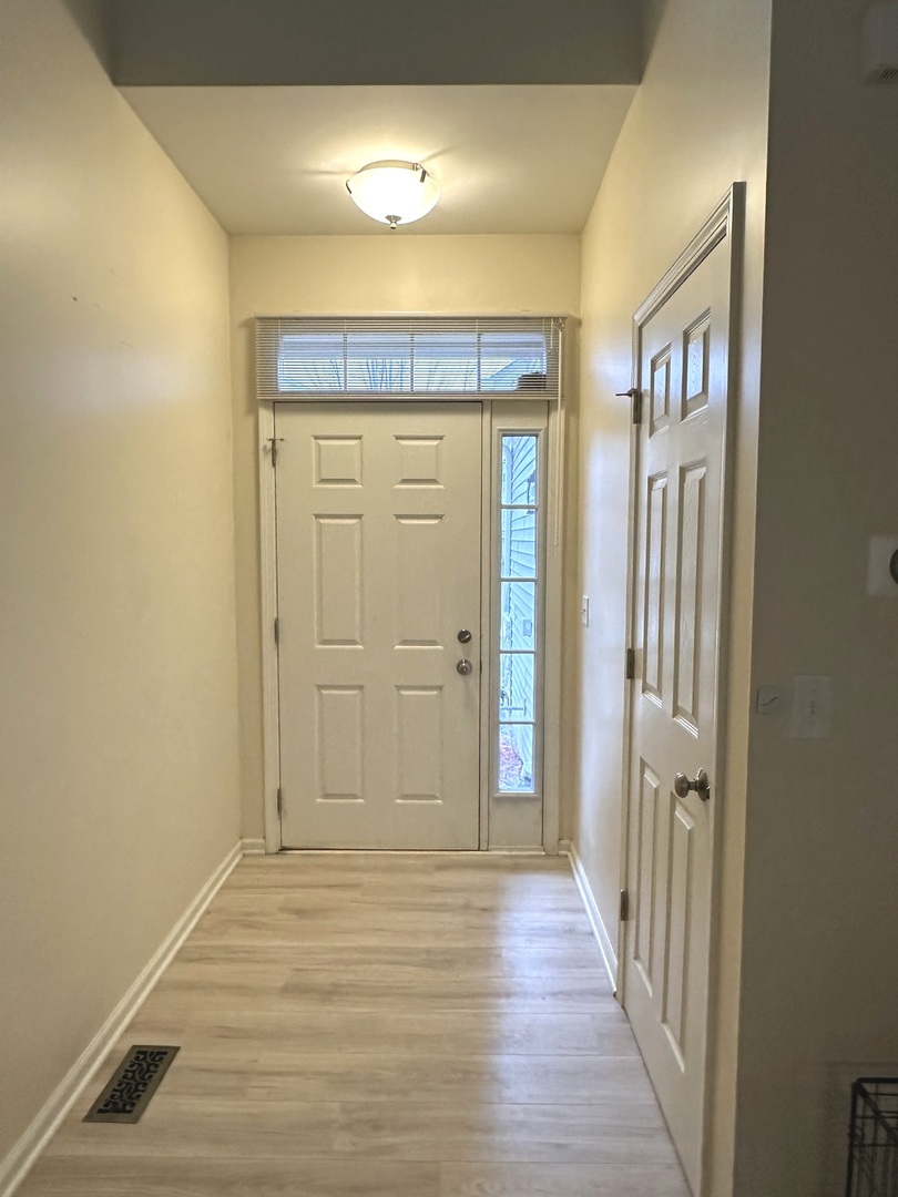 5102 Monroe Street Matteson, IL 60443 - Photo 4 of 54 a view of a hallway with wooden floor