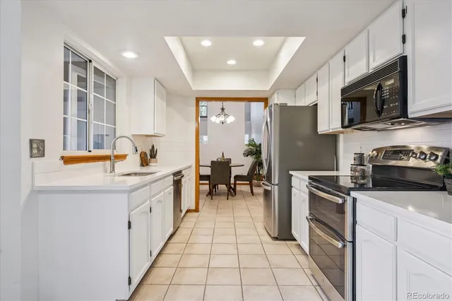 a kitchen with stainless steel appliances kitchen island granite countertop a sink and cabinets