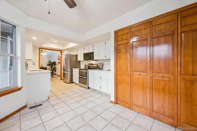 a kitchen with stainless steel appliances granite countertop a refrigerator and a stove top oven