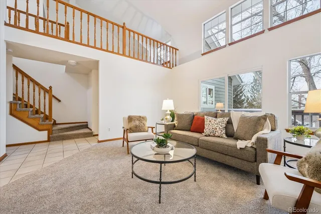 a living room with furniture and a dining table