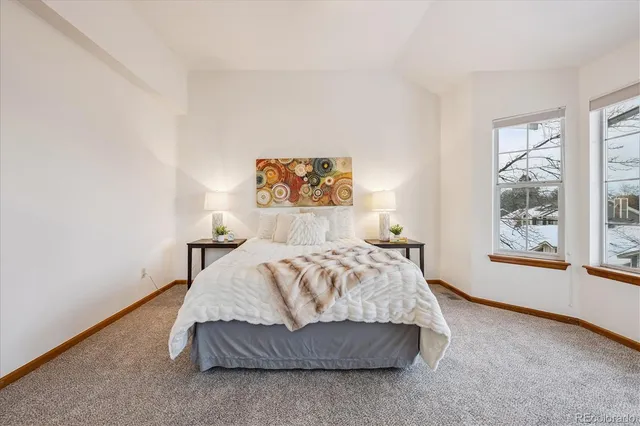 a spacious bedroom with a bed and a window