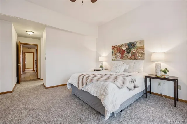 a bedroom with a bed and a painting on the wall