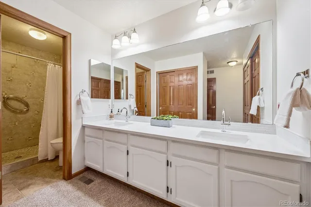 a bathroom with a granite countertop sink mirror and double