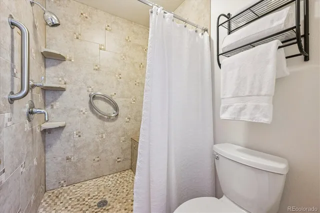a bathroom with a shower toilet and sink