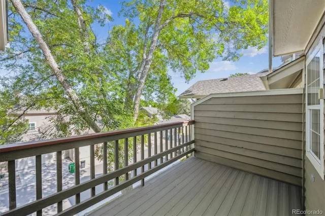 a view of a balcony with wooden floor