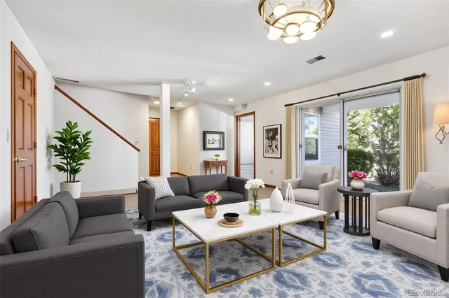 a living room with patio furniture and a large window