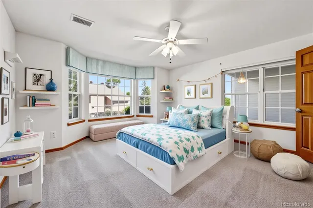 a bedroom with a bed and a large window