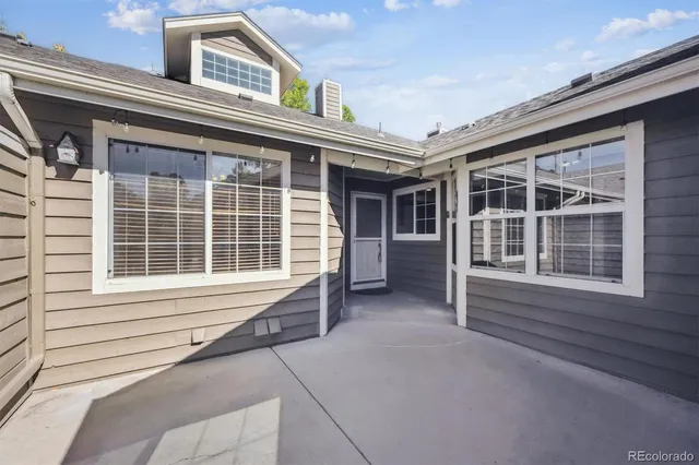 a view of a house with a large window and balcony