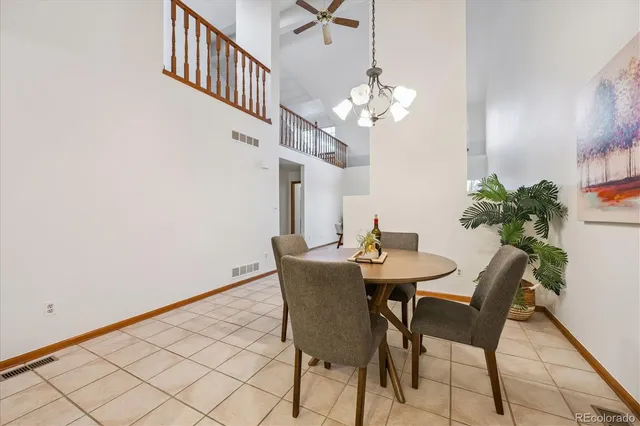 a view of a dining room with furniture and a chandelier