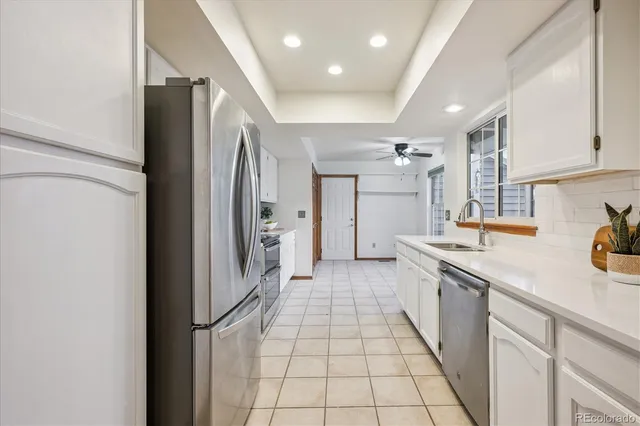 a kitchen with stainless steel appliances granite countertop a refrigerator and a sink