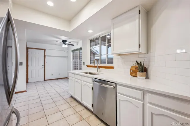a kitchen with a sink cabinets and appliances