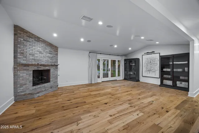 a kitchen with a white center island and stainless steel appliances