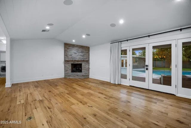 a kitchen with a stove and a wooden floor