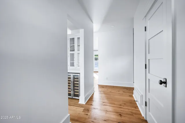 a view of an empty room with a fireplace and a window