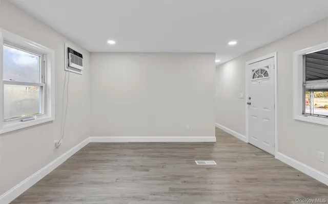 wooden floor in an empty room with a window