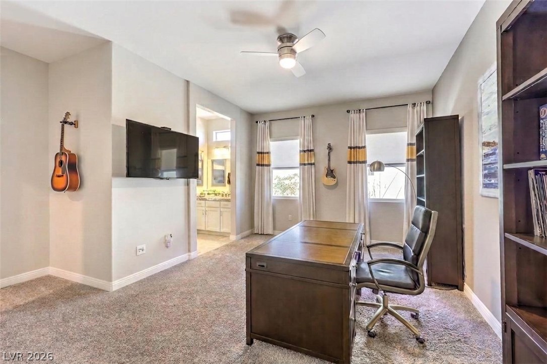 7119 Arabian Ridge Street Las Vegas, NV 89131 - Photo 41 of 73 A versatile home office area, thoughtfully designed for productivity and creativity, offers convenient access to a full bathroom.