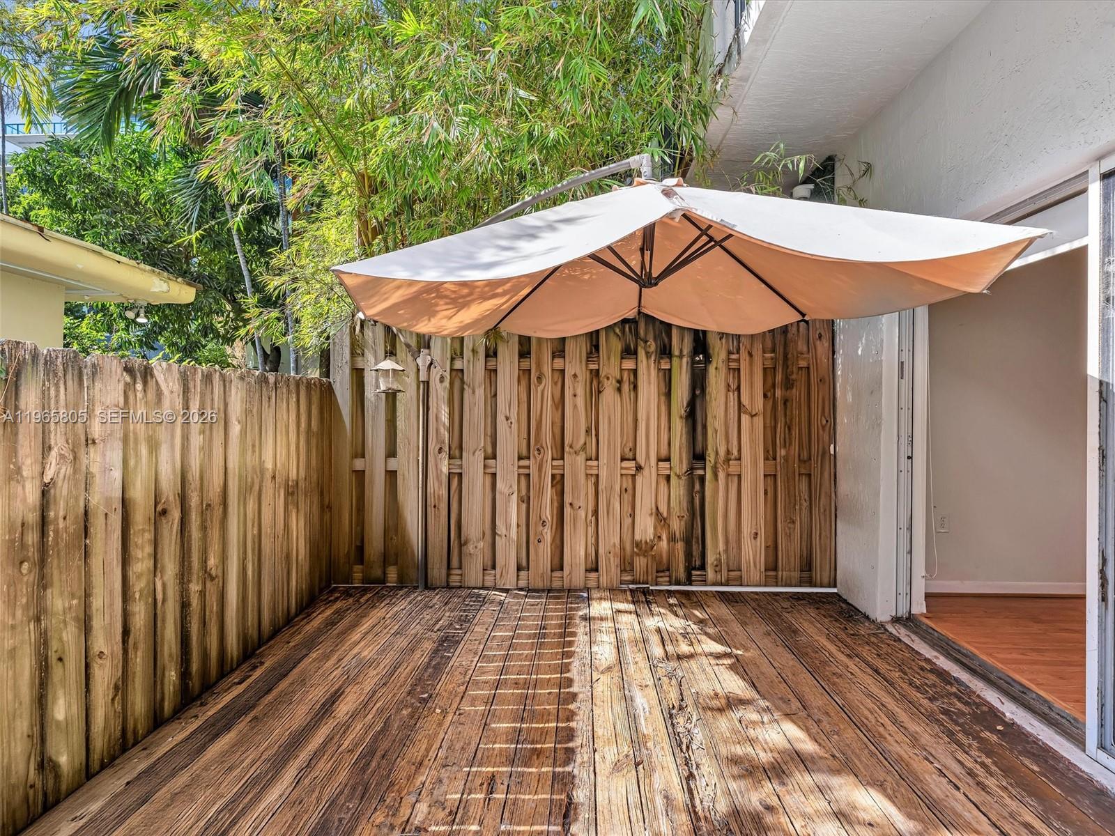 240 Southwest 15th Road, Unit 112 Miami, FL 33129 - Photo 15 of 47 a view of a patio with a table and chairs under an umbrella