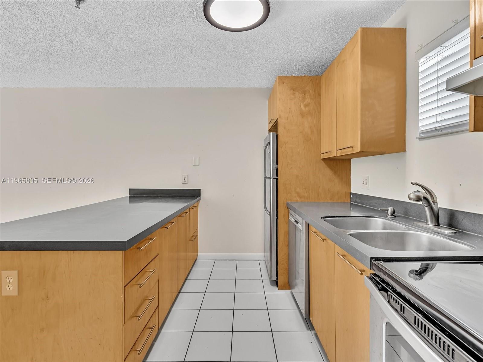 240 Southwest 15th Road, Unit 112 Miami, FL 33129 - Photo 30 of 47 a kitchen with stainless steel appliances granite countertop a sink and a stove