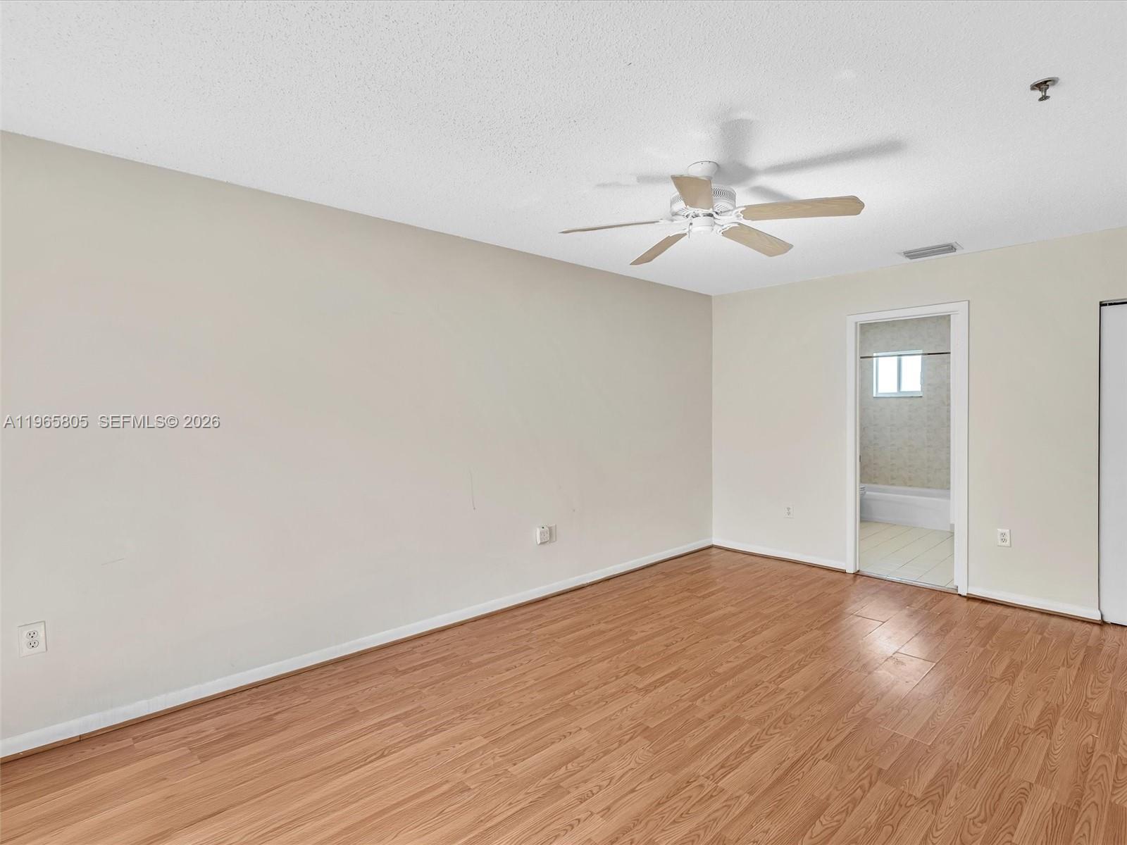 240 Southwest 15th Road, Unit 112 Miami, FL 33129 - Photo 35 of 47 an empty room with wooden floor and fan