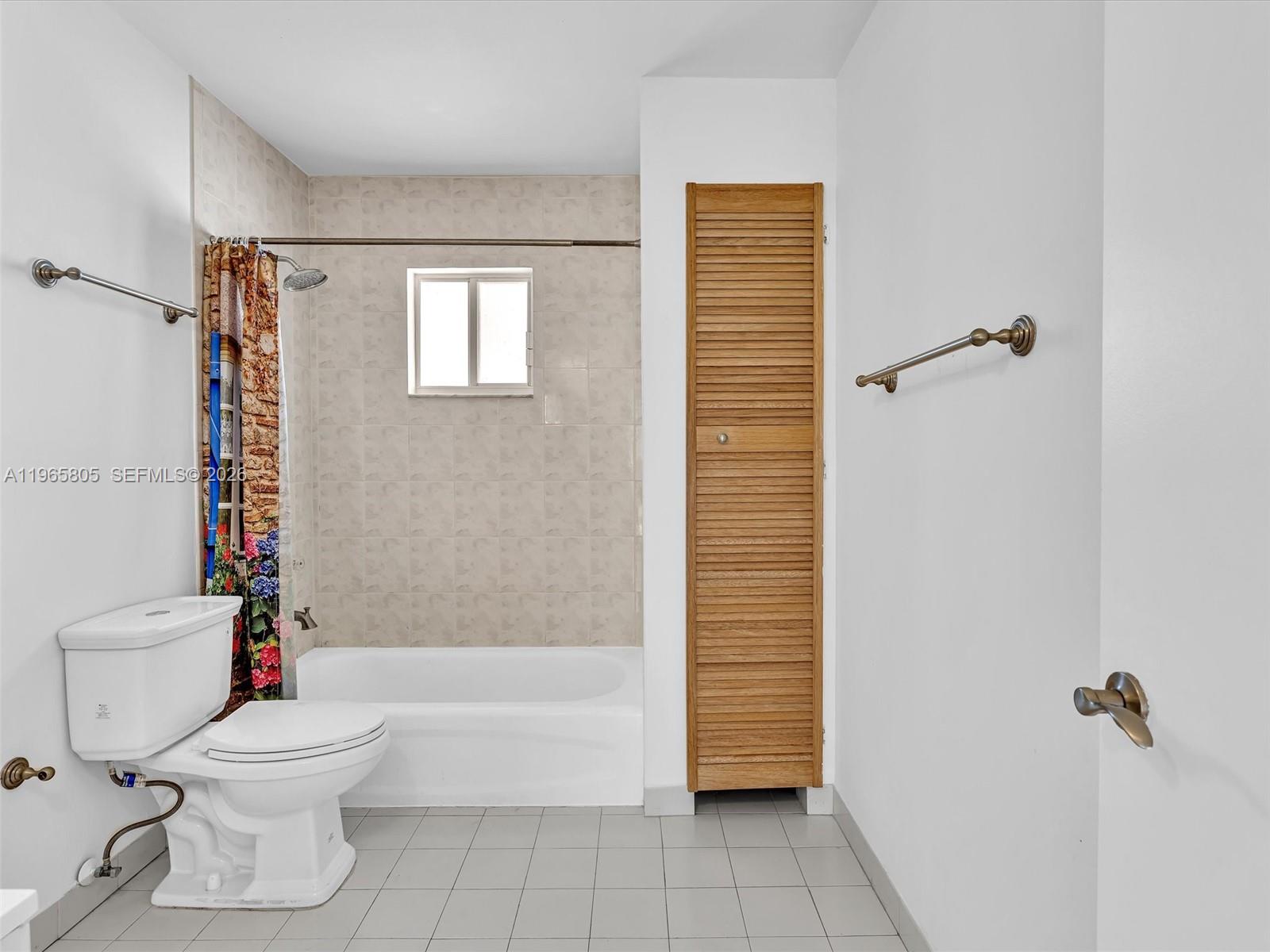 240 Southwest 15th Road, Unit 112 Miami, FL 33129 - Photo 38 of 47 a bathroom with a toilet and a shower