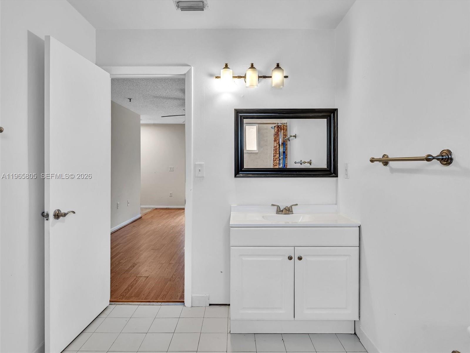 240 Southwest 15th Road, Unit 112 Miami, FL 33129 - Photo 39 of 47 a bathroom with a sink mirror and vanity