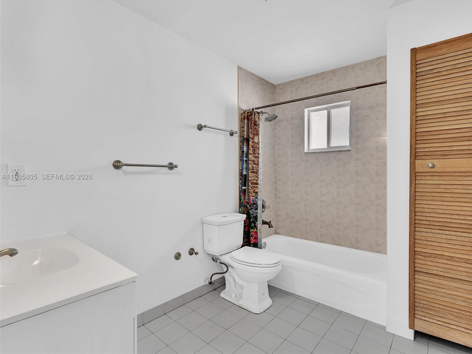 240 Southwest 15th Road, Unit 112 Miami, FL 33129 - Photo 5 of 47 a white toilet sitting next to a bath tub