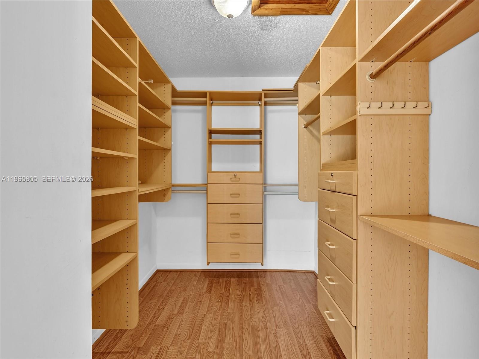 240 Southwest 15th Road, Unit 112 Miami, FL 33129 - Photo 6 of 47 a view of walk in closet with empty racks